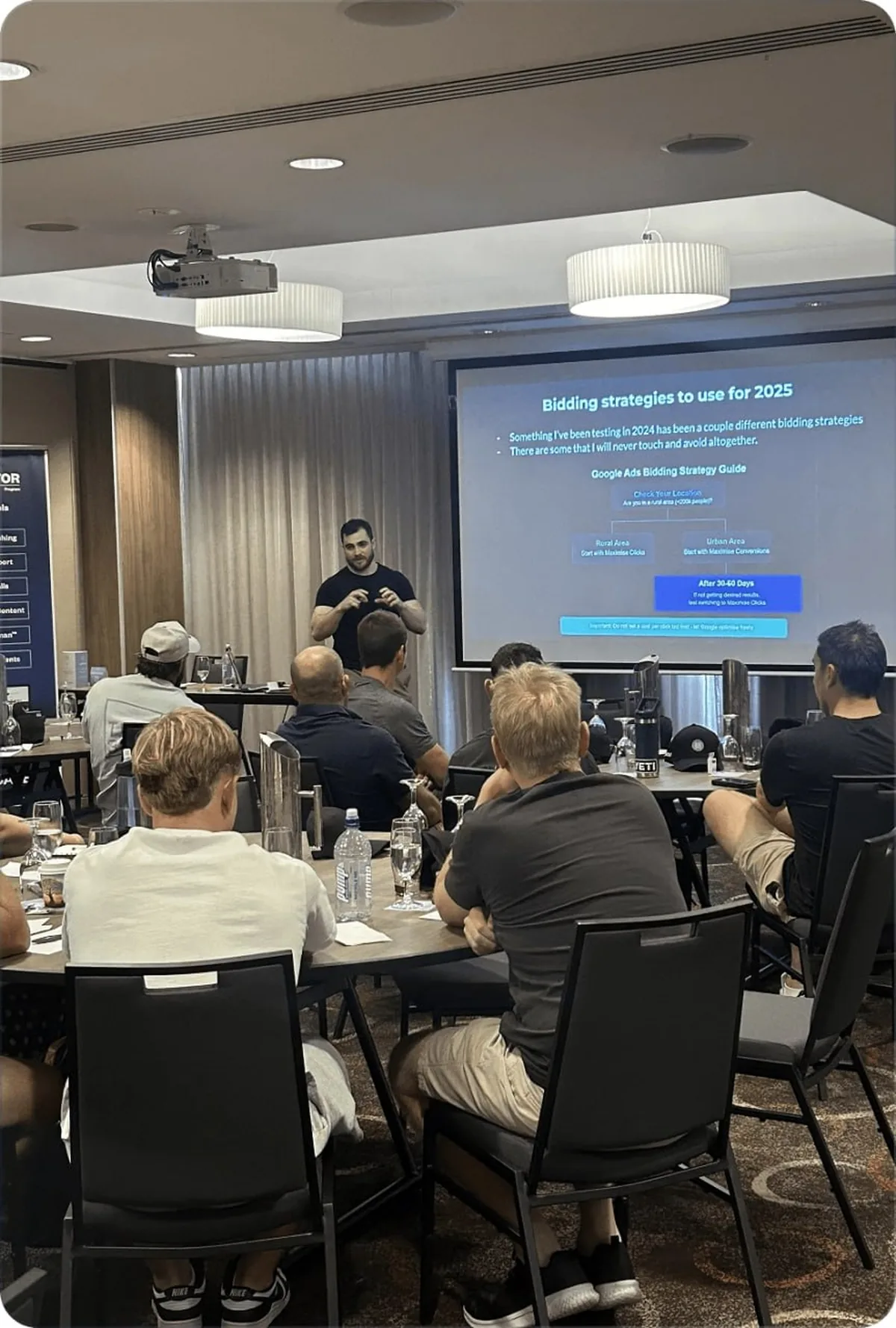 Jordan Pizzica presenting Google Ads bidding strategy to a room of Australian tradies